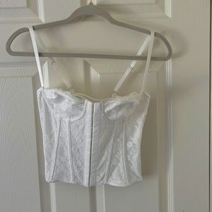 Lace white corset top with crisscross back and hook and eye front.